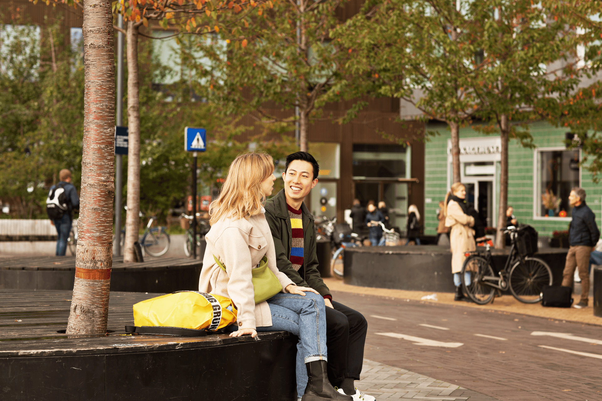 two people talking at  square at Bohrs Tower and Carslberg Station